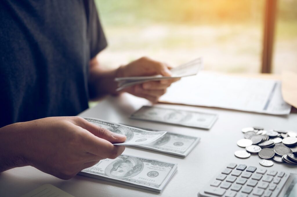 Asian men are holding banknotes in cash