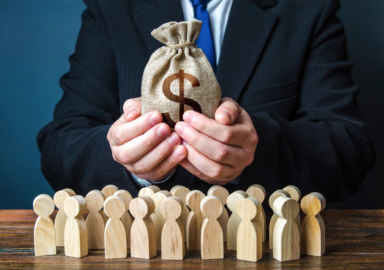Businessman holds out a dollar money bag