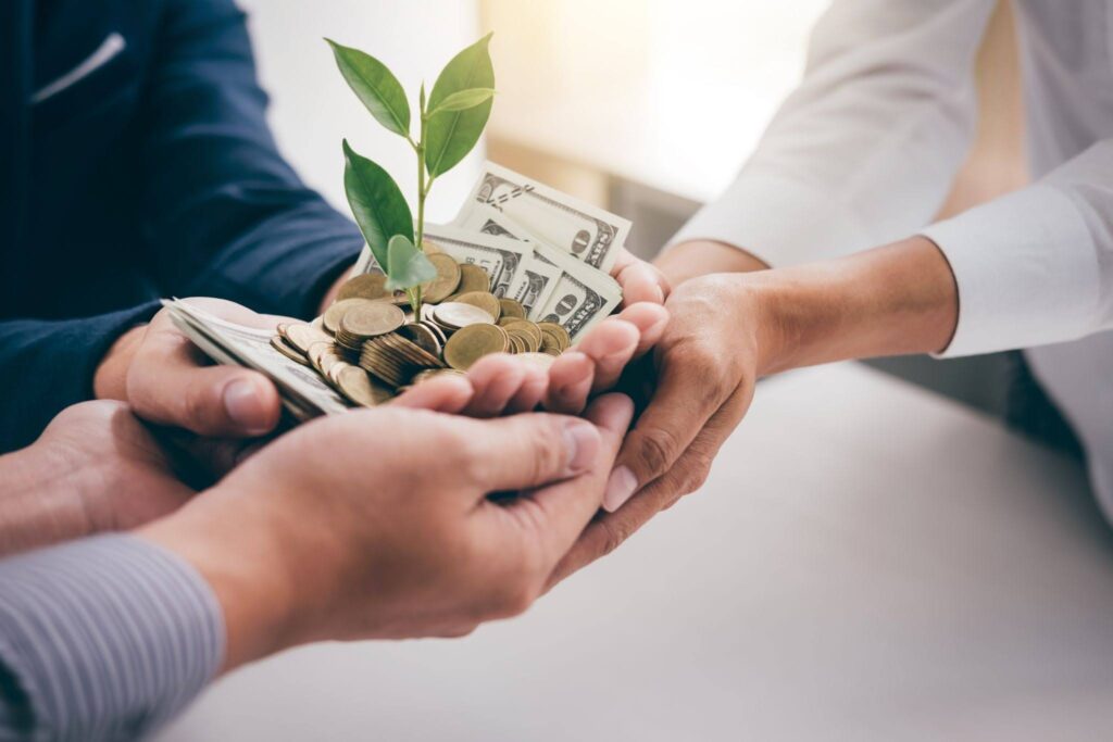 three people holding their hands with money on it 