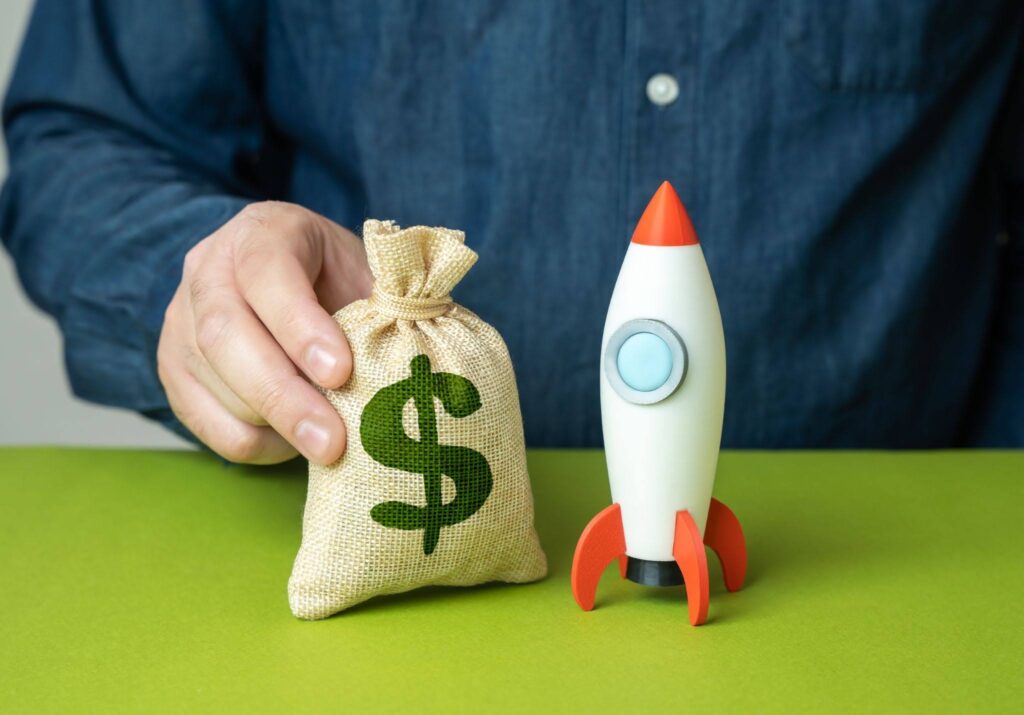 man holding bag of dollars