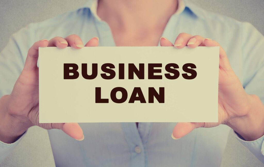 man holding board of business loan