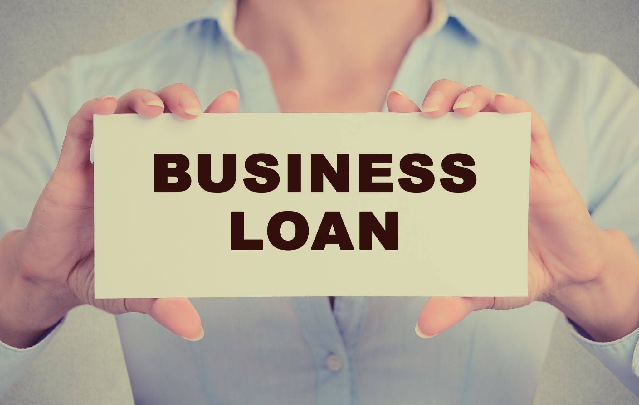 man holding board of business loan