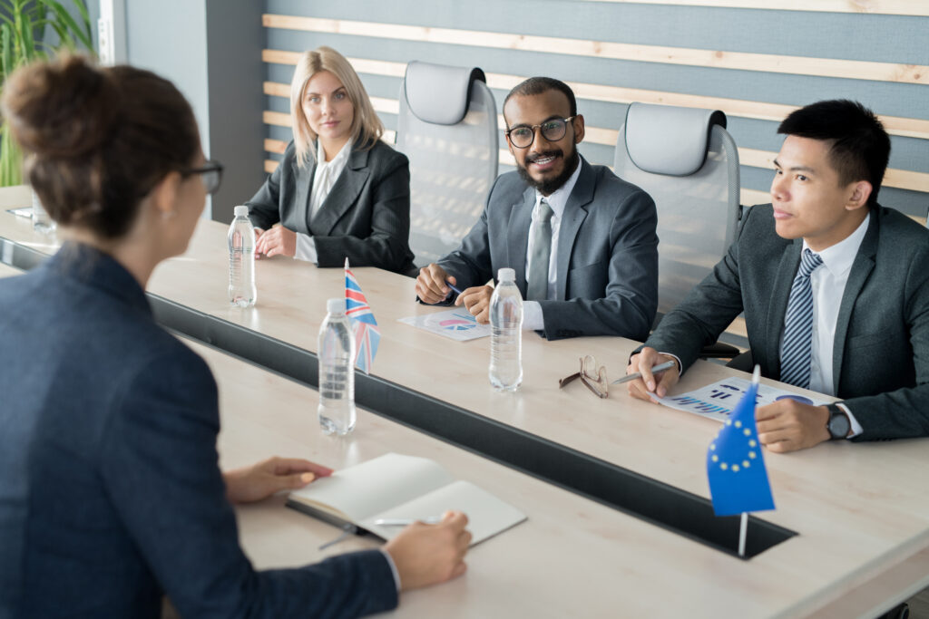 Business Meeting with Flags at Conference Table
