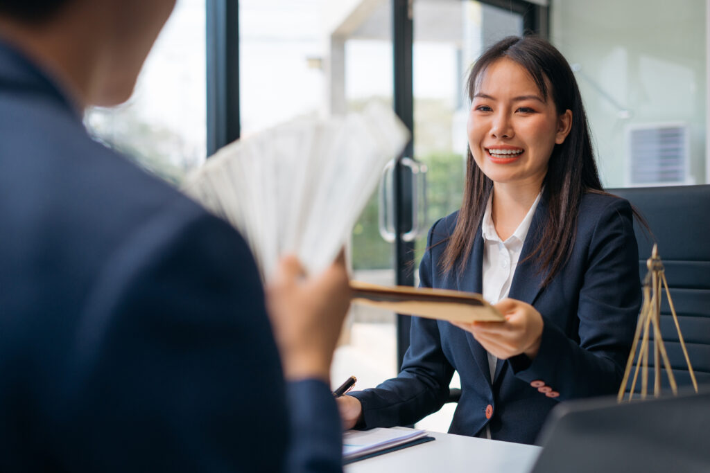Businessman giving money in the envelope to partner 