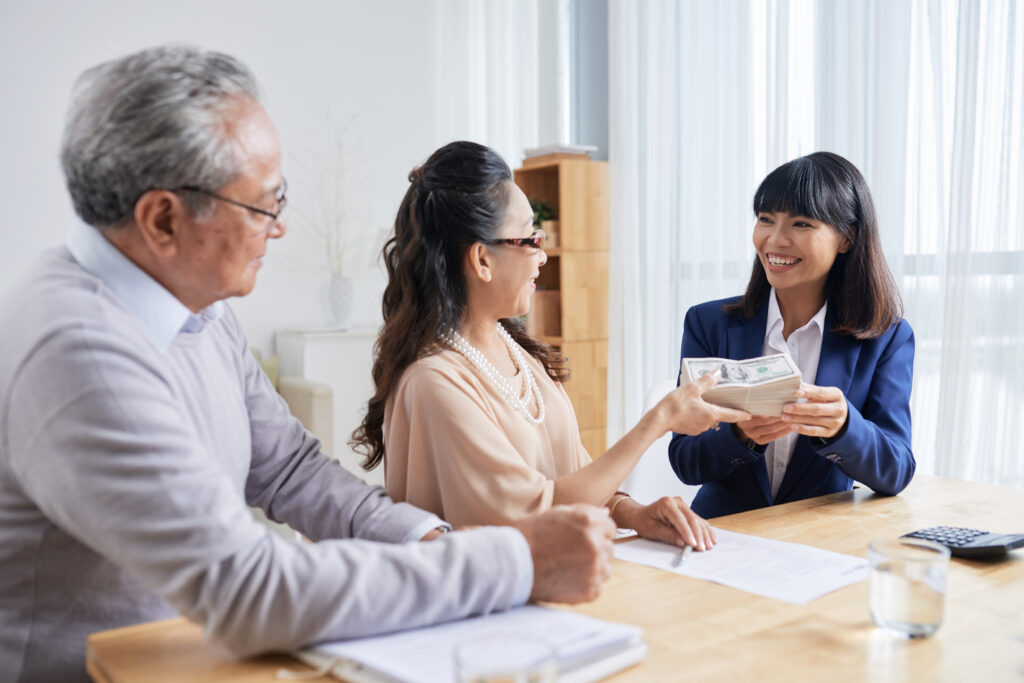 Couple Giving Money Estate Manager