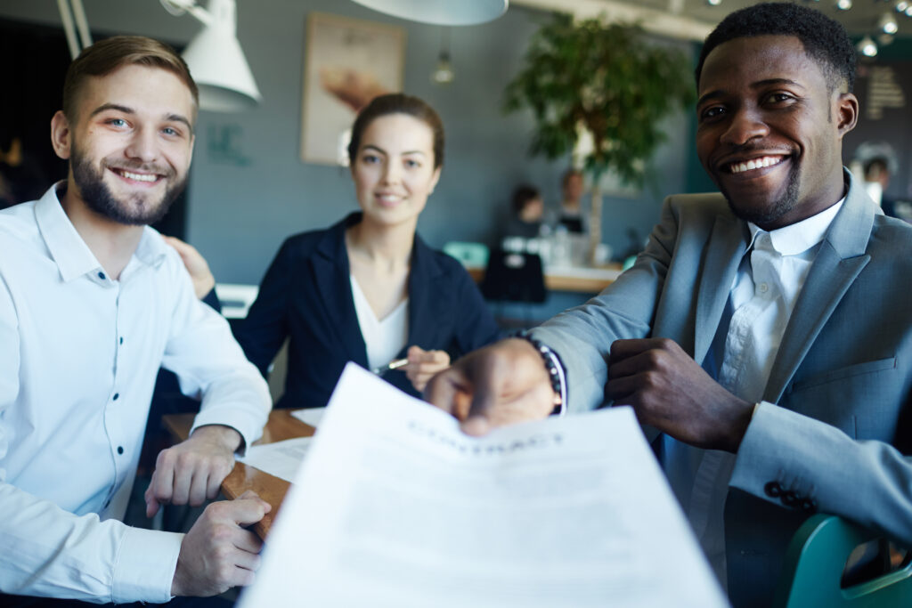 three business professionals reviewing documents.
