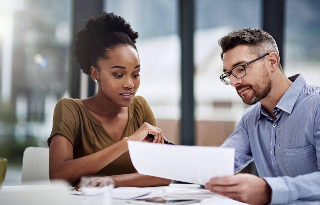 Business Professionals Discussing Documents at a Desk