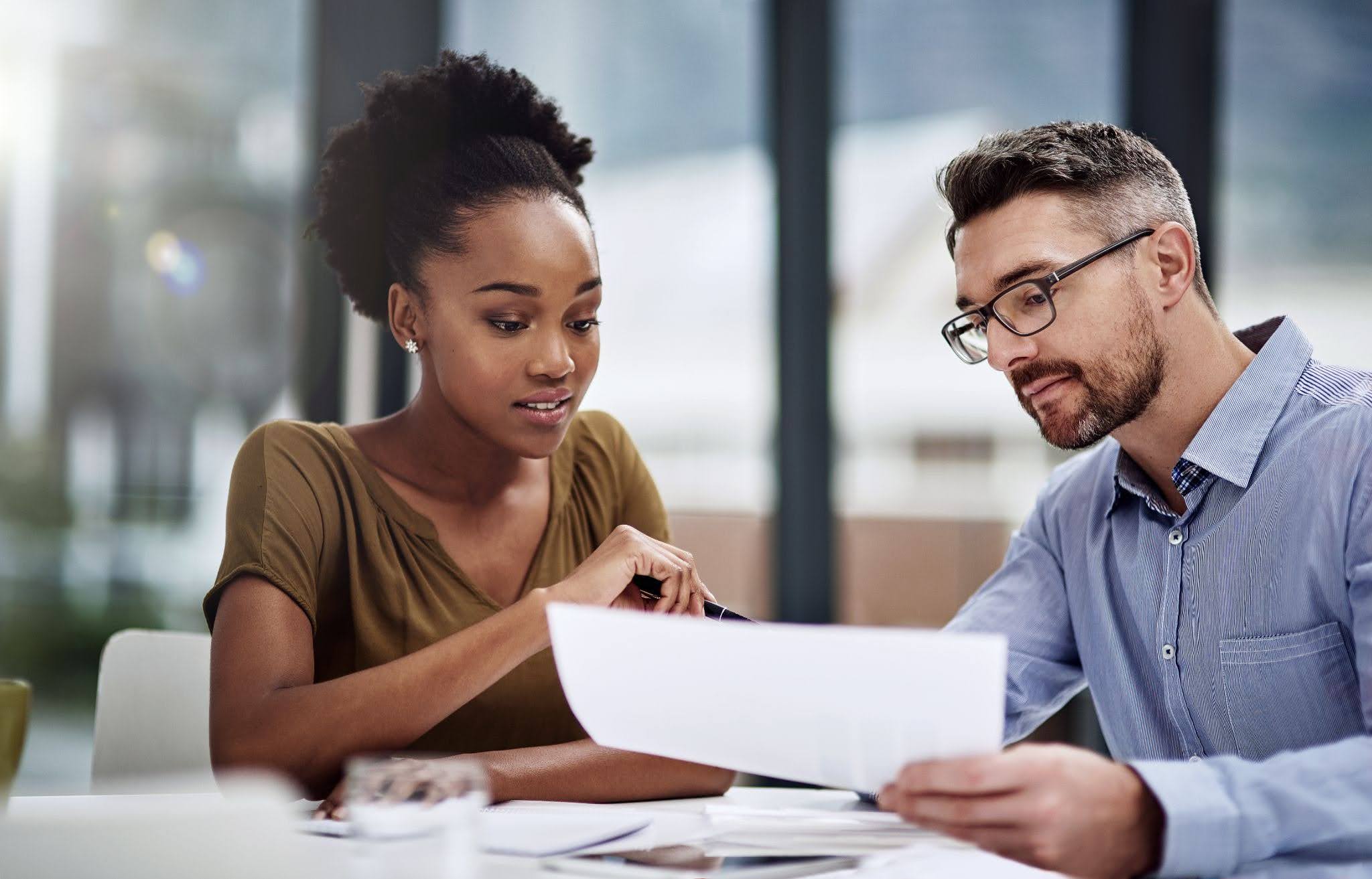 Business Professionals Discussing Documents at a Desk