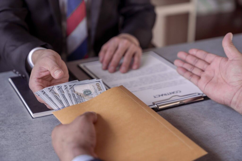 Business Deal Involving Money Exchange in Office