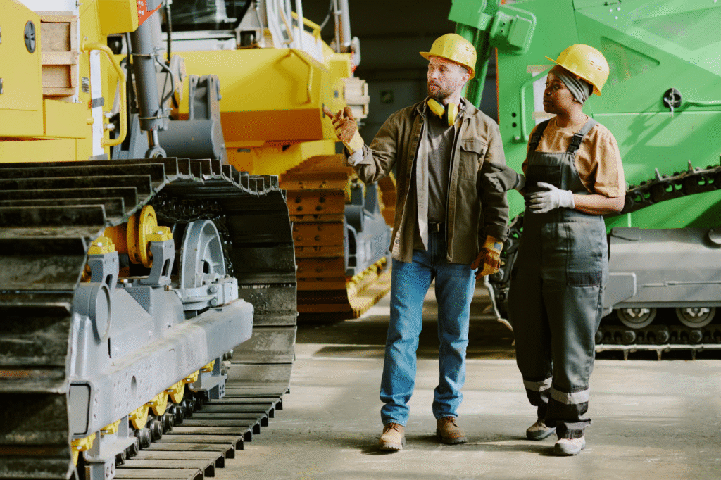 Two Colleagues Having Conversation At Work In Industrial Plant