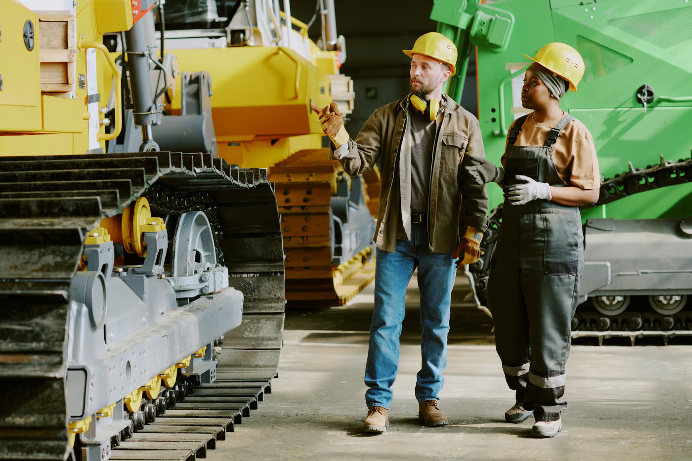 Two Colleagues Having Conversation At Work In Industrial Plant