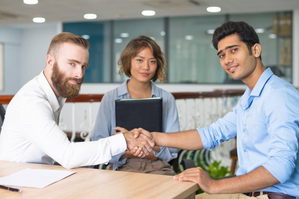 candidate shaking hands with company leader