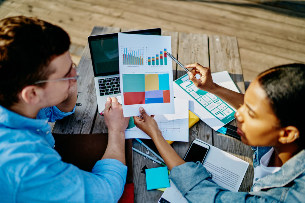 Young Adults Collaborate Reviewing Business Data