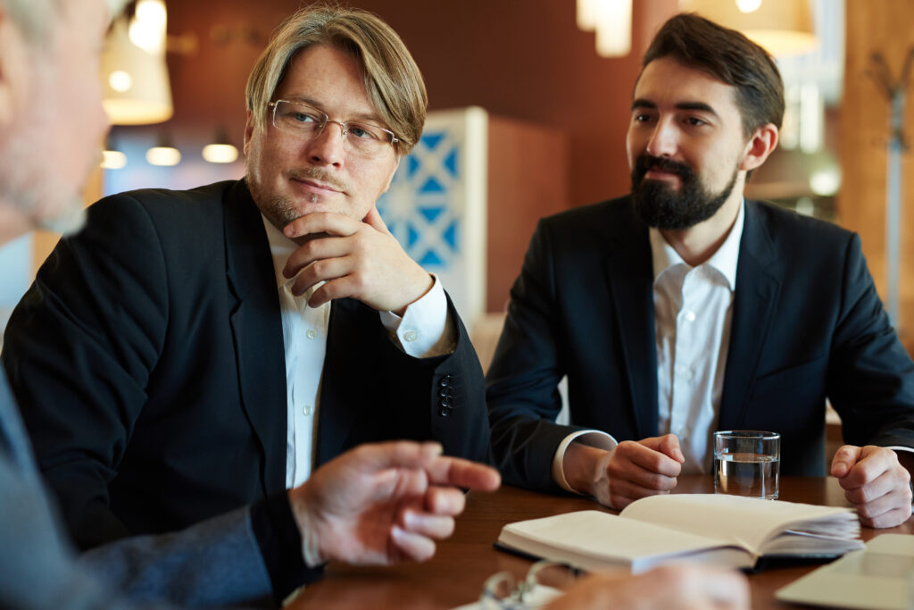 Attentive men listening to colleague explanation
