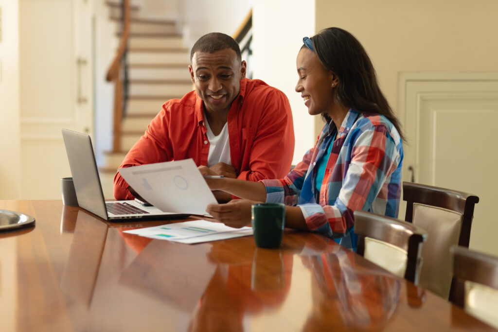 smiling african american couple calculating budget