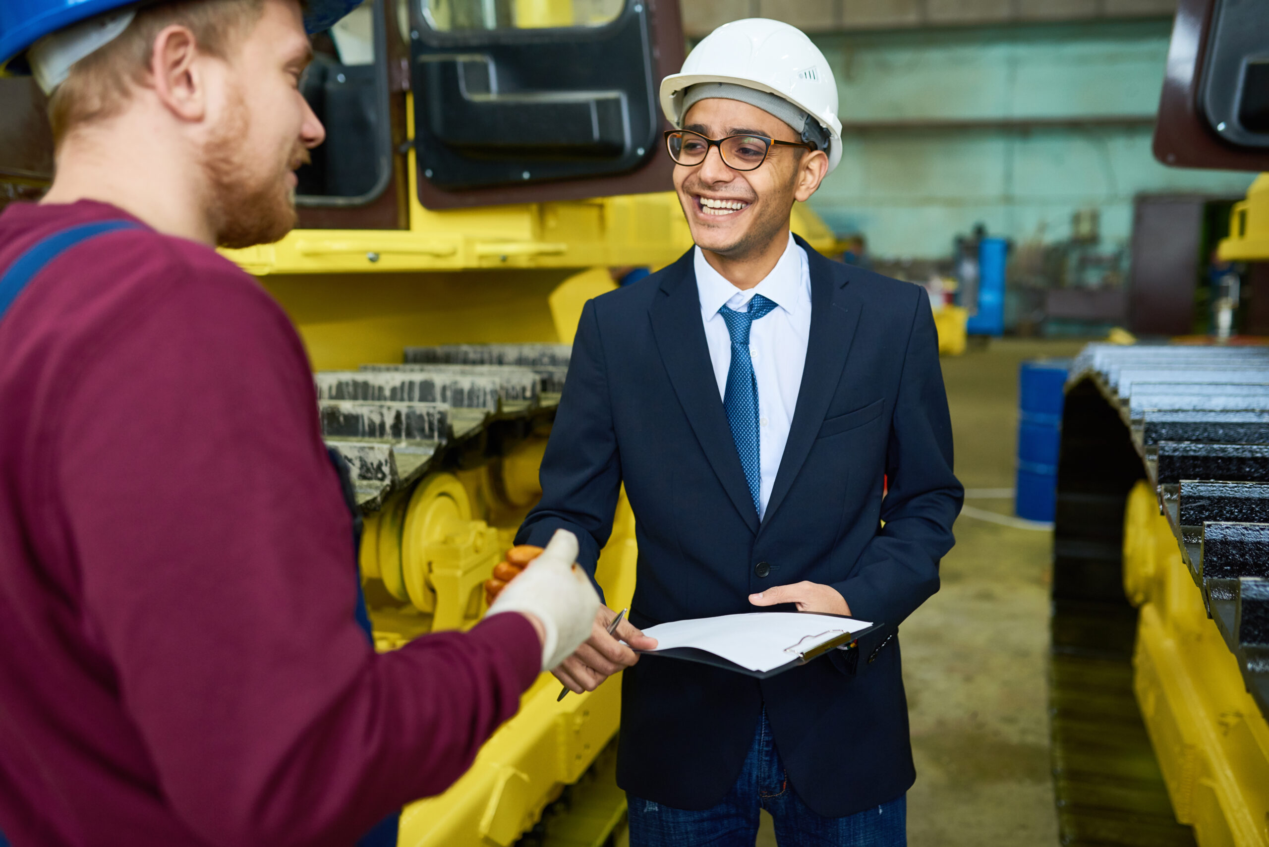 Smiling Young Businessman at Plant