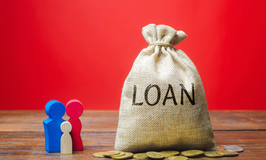 Loan Concept with Wooden Figures and Gold Coins